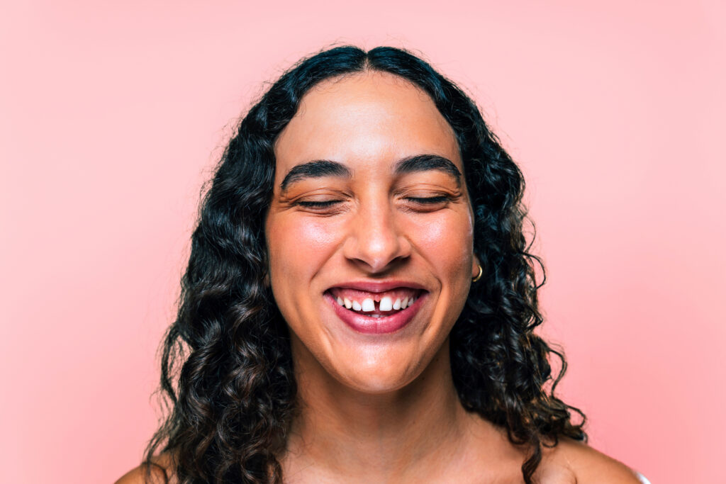 Beauty studio portrait of beautiful young woman with diastema - Confident and interesting female with diverse and unique style, concepts about skin care, body care, individuality and body acceptance
